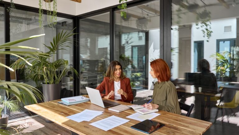 Professionals in a co-working space using Phoneserv cloud phone system for flexible communication and real-time collaboration
