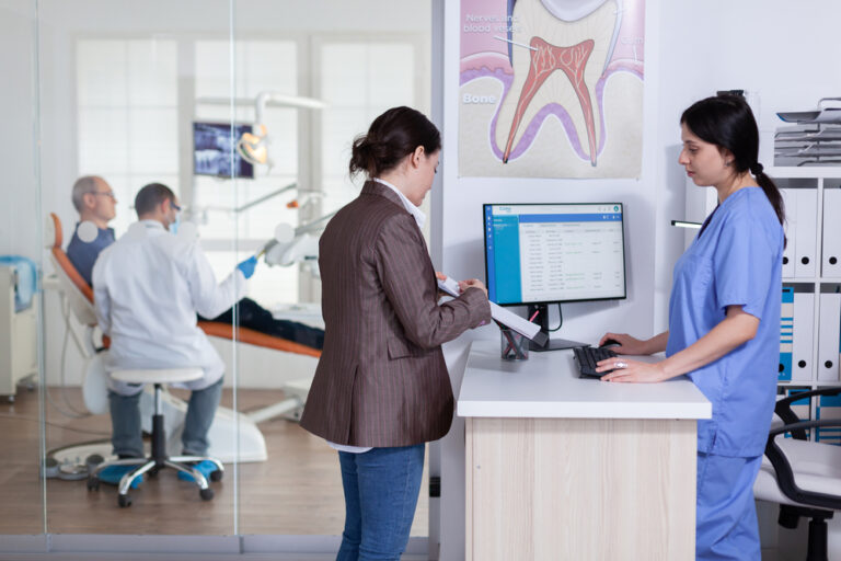 Dental clinic staff coordinating appointments and patient calls using Phoneserv cloud communication system across multiple locations
