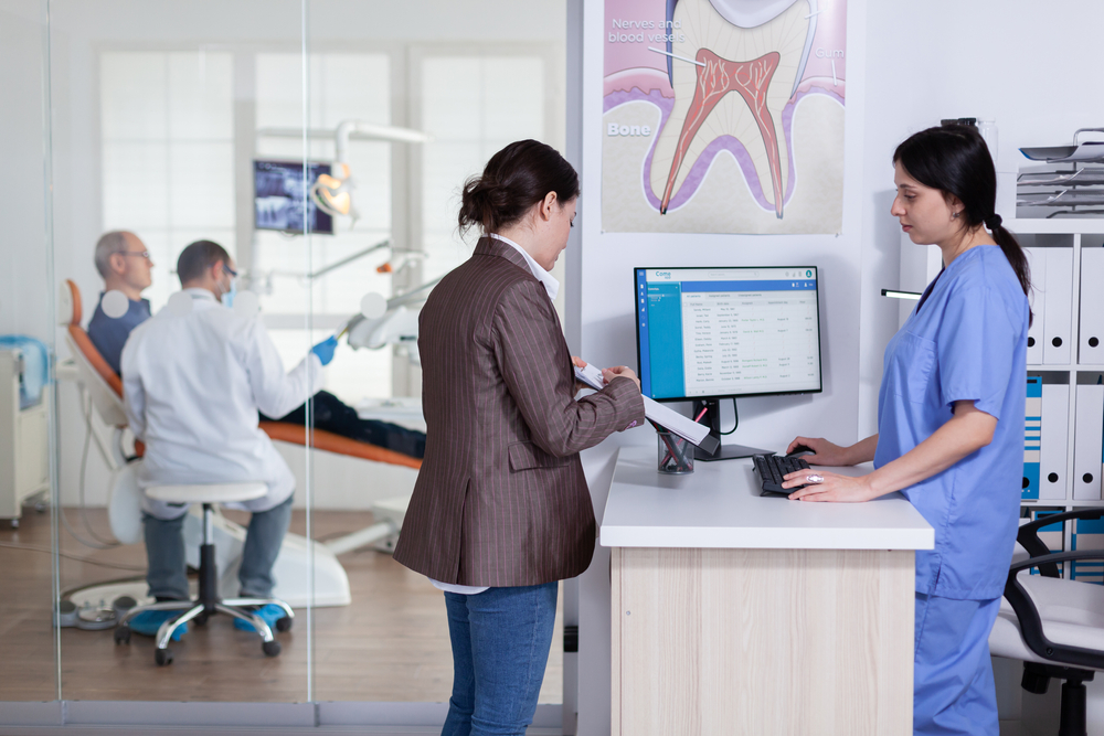 Dental clinic staff coordinating appointments and patient calls using Phoneserv cloud communication system across multiple locations